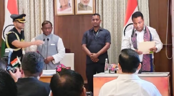 Governor Laxman Prasad Acharya administering the oath to Charan Boro as Assam Cabinet Minister.