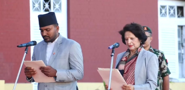 The newly appointed minister takes the oath of office. The newly appointed minister takes the oath of office.