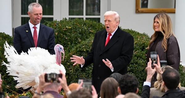 First lady Melania Trump looks on as President Trump pardons Gobble, one of the National Thanksgiving Turkeys