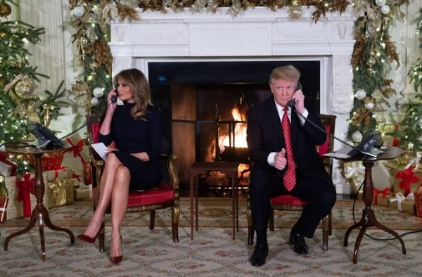 Donald Trump and Melania Trump answer calls at White House on Dec. 24.