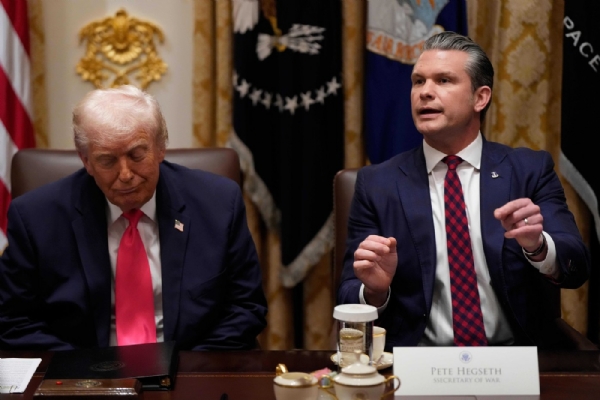 Defense Secretary Pete Hegseth speaks as President Donald Trump looks on, during a Cabinet meeting at the White House, Tuesday, Dec. 2, 2025, in Washington. Defense Secretary Pete Hegseth speaks as President Donald Trump looks on, during a Cabinet meeting at the White House, Tuesday, Dec. 2, 2025, in Washington.