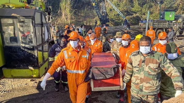 Assam: Soldiers of the 1st Battalion NDRF carrying the bodies of workers who lost their lives in the coal mine accident.