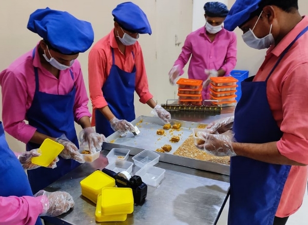 Workers packing prasad. Somnath Temple