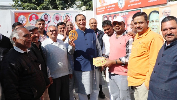BJP State President Mohanlal Badauli celebrates victory with workers with Jalebi in Delhi