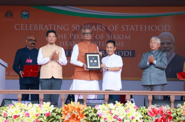 The Governor of Sikkim, Om Prakash Mathur, and Chief Minister Prem Singh Tamang issuing a silver coin worth ₹50 and a commemorative postage stamp.