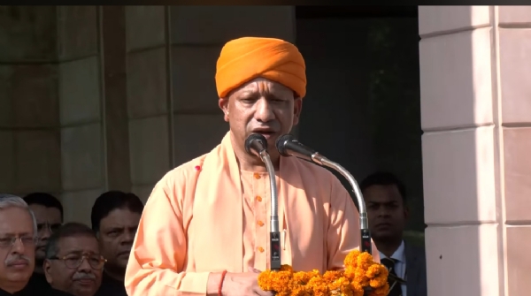 Chief Minister Yogi Adityanath addressing gathering after hoisting flag at his official residence