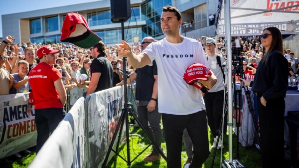 Charlie Kirk hands out hats before speaking at Utah Valley University in Orem, Utah, Wednesday, Sept. 10, 2025.