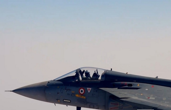 Indian Air Force Chief Air Chief Marshal A.P. Singh waves in greeting after flying in the indigenous Tejas fighter aircraft.
