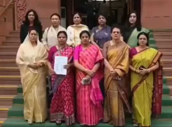 A BJP delegation gathers at the Makar Dwar of Parliament.