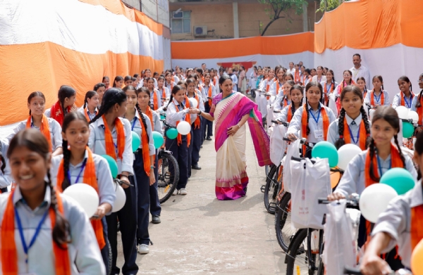 Delhi Chief Minister Rekha Gupta distributes bicycles to students.