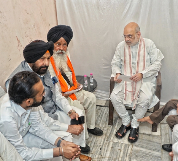 Home Minister Amit Shah meeting with the father of Parvinder Singh Jhota in Mansa
