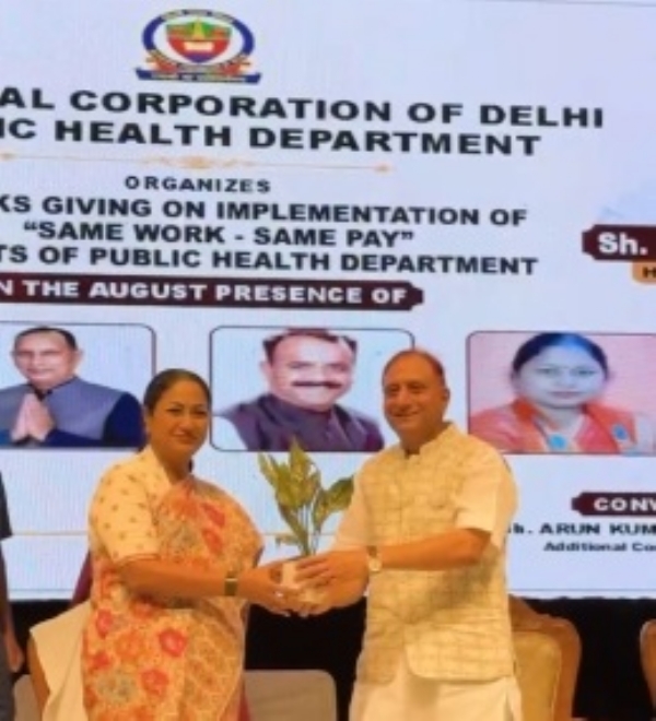 Delhi Chief Minister Rekha Gupta accompanied by other officials and attendees.