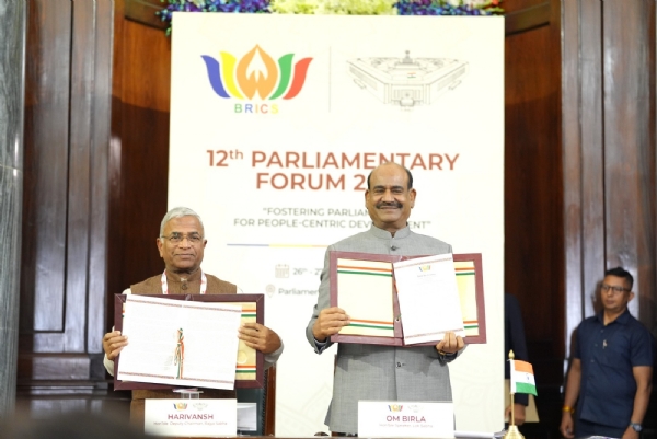 Lok Sabha Speaker Om Birla and Rajya Sabha Deputy Chairman Harivansh pose with the BRICS Parliamentary Forum declaration on Tuesday.