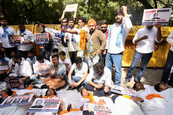 NSUI workers stage a symbolic protest against alleged “vote theft,” appearing as “living corpses” to convey their message.