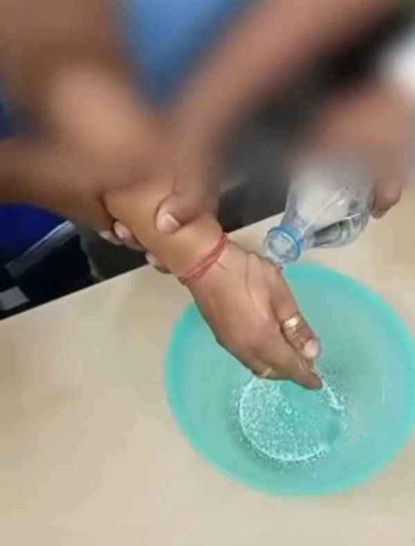 The hand of the accused is being wahsed