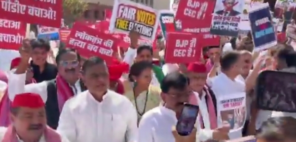 Samajwadi Party workers take part in a march against Chief Election Commissioner Gyanesh Kumar.