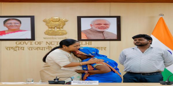 Delhi CM Rekha Gupta Hands Over Rs.1 Crore Cheques to Families of Martyred Corona Warriors