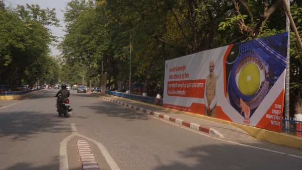 Route along public meeting venue adorned with BJP flags and huge posters, banners, and cutouts