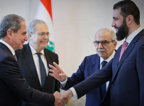 Syrian President al-Sharaa shakes hands with Lebanon’s Prime Minister Salam at Damascus’s People’s Palace