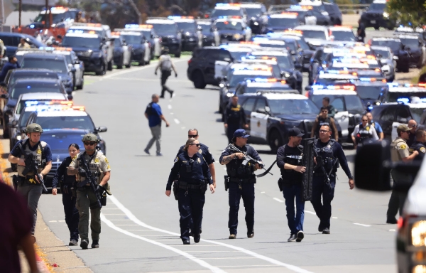 Police officers escorted civilians away from the Islamic Center of San Diego following reports of gunfire at the mosque.