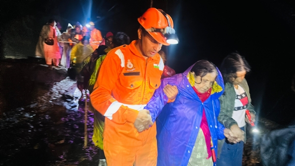 Police rescuing people trapped in a landslide.