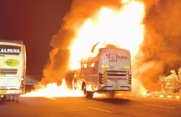 Double-decker bus collided with an overturned sand-laden truck