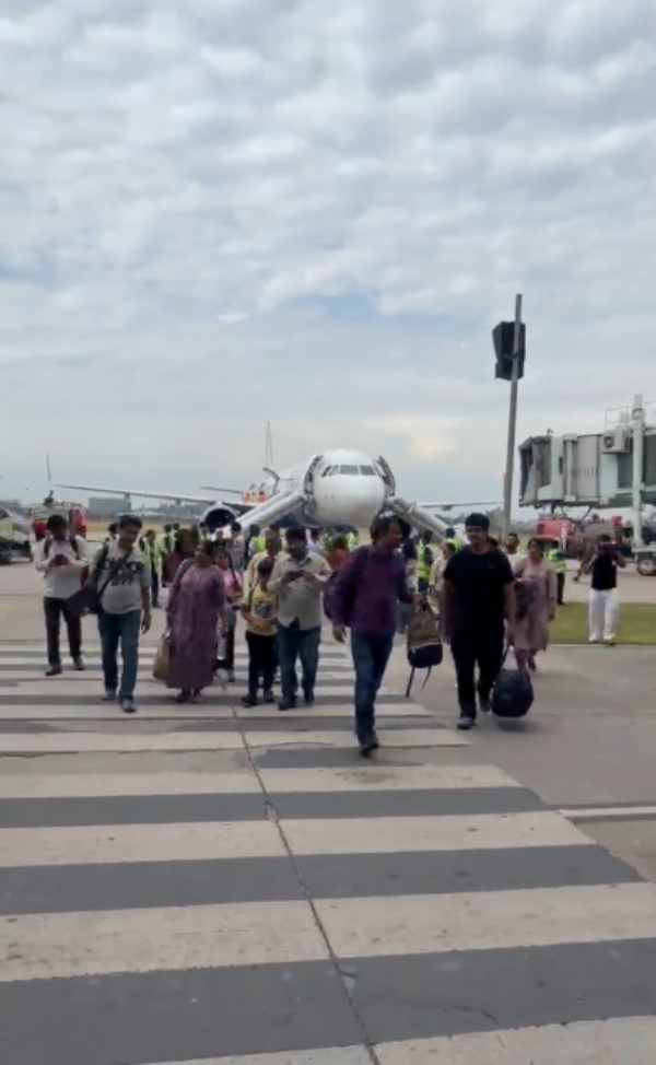 Passengers coming out from the flight Passengers coming out from the flight