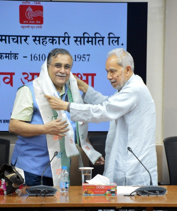Senior journalist Rambhadur Rai congratulates Arvind Bhalchandra Mardikar after his election as Chairman on Wednesday at the Indira Gandhi National Centre for the Arts in New Delhi. Photo: Hindusthan Samachar.