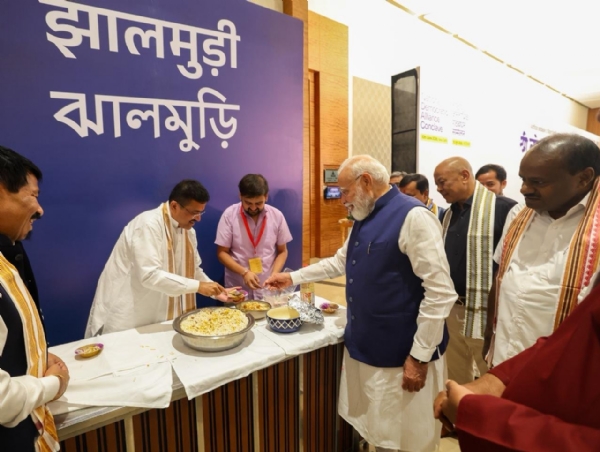 Prime Minister Narendra Modi enjoying jhalmuri during the NDA meeting.