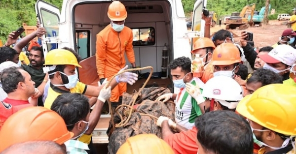 Officials and volunteers involved in the search operation carry the body of Vikram Rana to an ambulance after it was recovered Officials and volunteers involved in the search operation carry the body of Vikram Rana to an ambulance after it was recovered