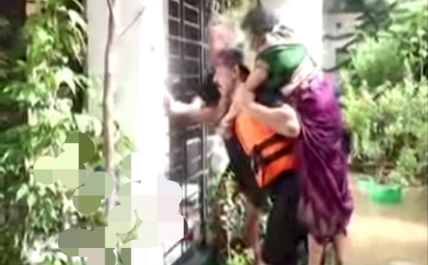 Civil Defence Personal Rescuing Women in Floodwaters in Guwahati on Friday.