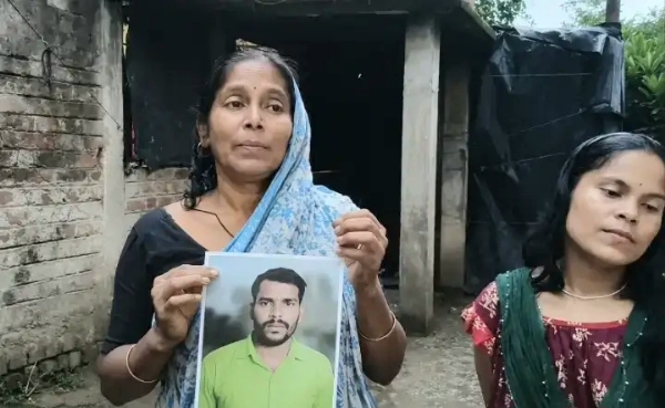 The family members of the missing youth with his photo in hand