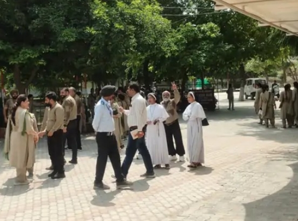 School staff outside the school building.