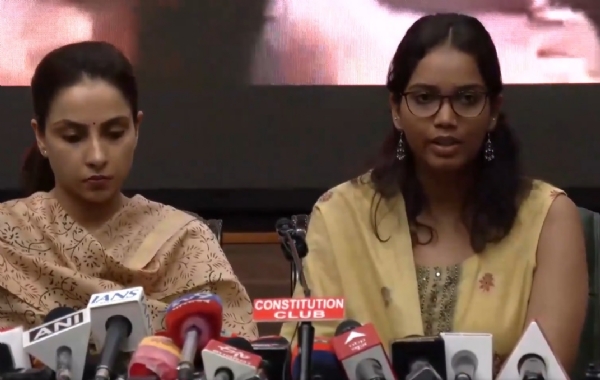 Family members of police personnel addressing a press conference.