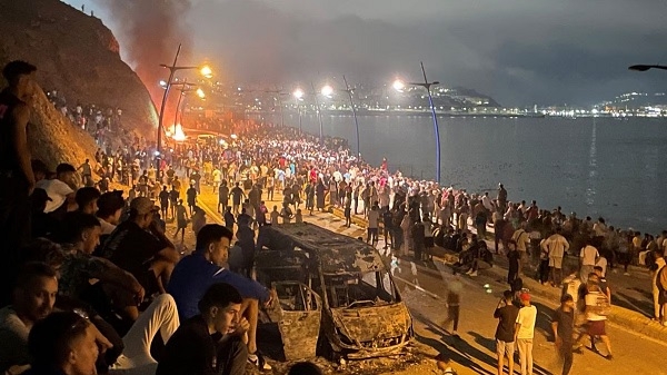 People gather near the Morocco border in Ceuta, Spain, amid departures from Spanish territory.