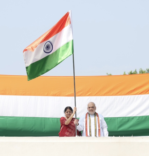 Union Home Minister Amit Shah and his wife unfurl the Tricolour.