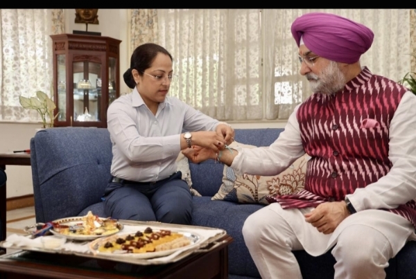 Delhi Lieutenant Governor Taranjit Singh Sandhu ties a rakhi with a security personnel. Delhi Lieutenant Governor Taranjit Singh Sandhu ties a rakhi with a security personnel.