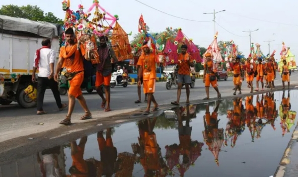 Pilgrims carrying sacred Ganga water in Kanwars from Haridwar have begun their return journey. A group of Kanwar pilgrims is seen passing near the Inter-State Bus Terminal (ISBT) in Delhi.
