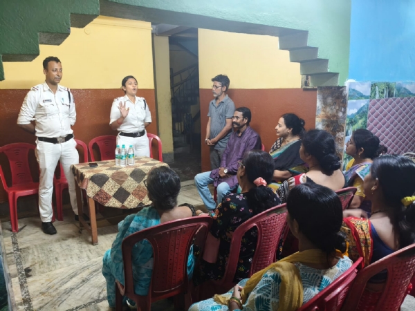 An officer addressing women