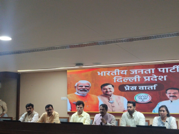 Delhi BJP President Harsh Malhotra addressing a press conference alongside party legislators.